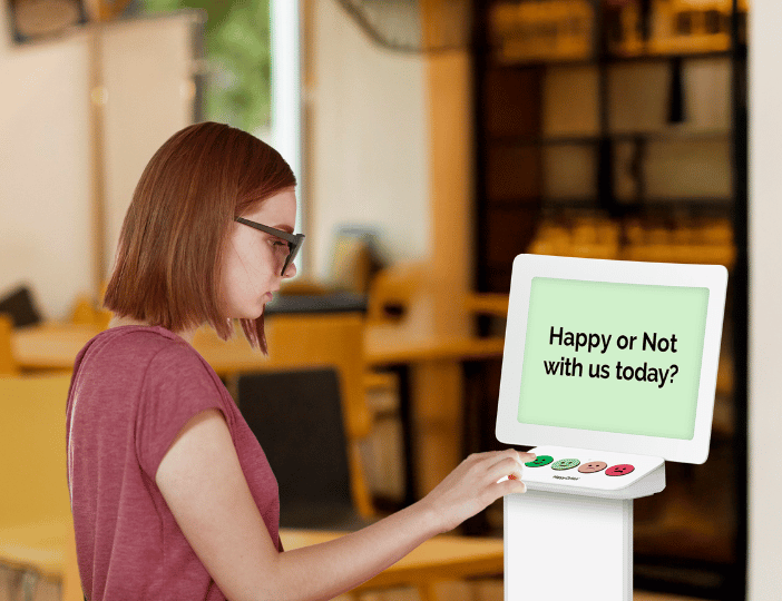 Elementary-school-student-giving-school-lunch-feedback-with-a-Smiley-Terminal-kiosk